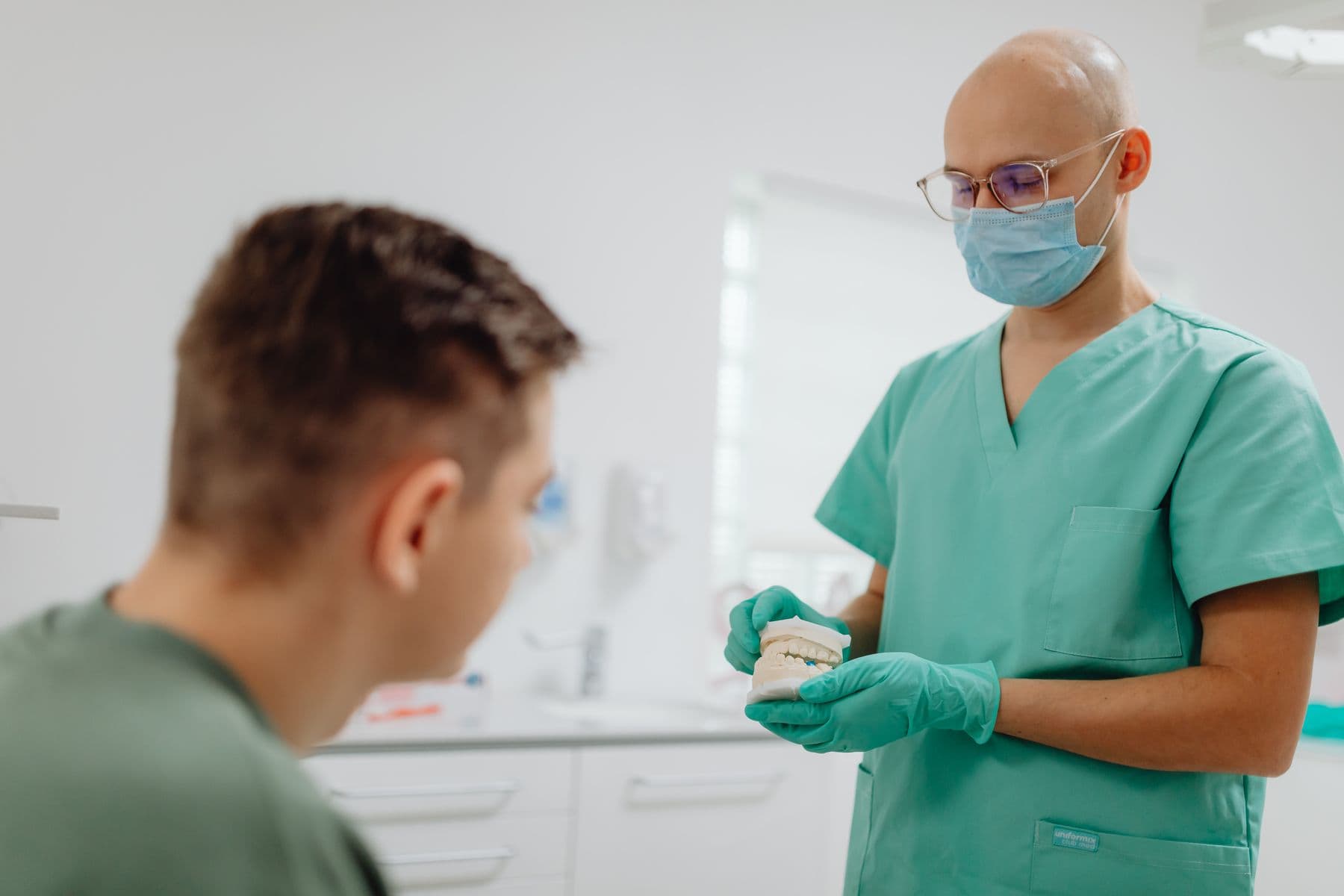 A dentist talking a patient through their treatment plan